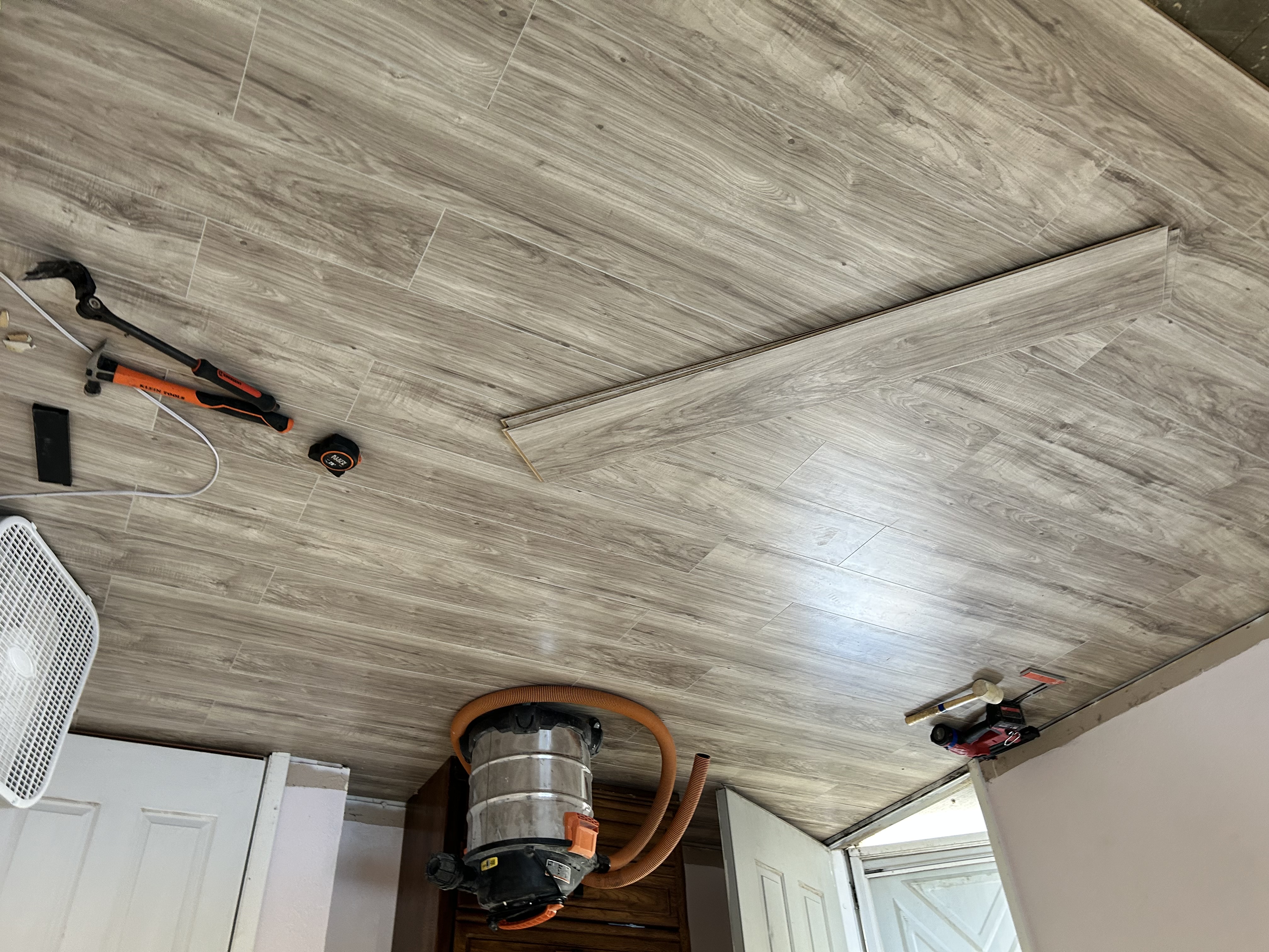 LVP flooring mid-install with tools